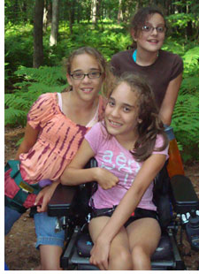 Campers Emma, Anna and Olivia stop for a photo during their hike at Agassiz Village.