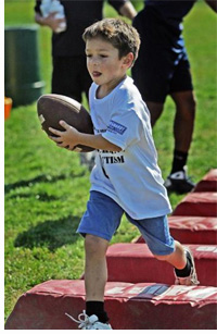Photo of Mateo running with a football, courtesy of Angela Peterson, Milwaukee Journal Sentinel