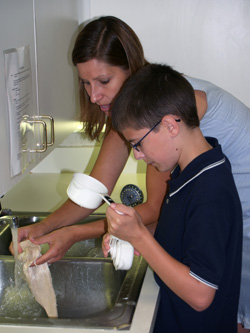 Woman and child washing dishes