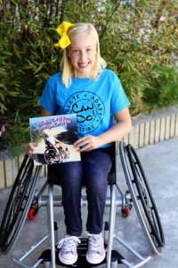Katie smiling and showing off her book. Picture from her website