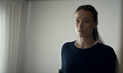 Actress Olivia Wilde, who does not have Down Syndrome, looking in a mirror. This is a screenscrab from the "How Do You See Me?" video referenced by BlindBeader.