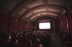 A movie theatre with people all looking at a screen
