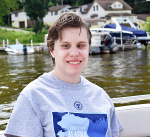 That's Alicia,a young woman with short brown hair, she's all smiles as the boat she's on passes by a deck at their uncle's place in Fox Lake. 