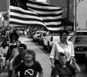 historical photo of a protest attended by people with disabilities, people using wheelchairs