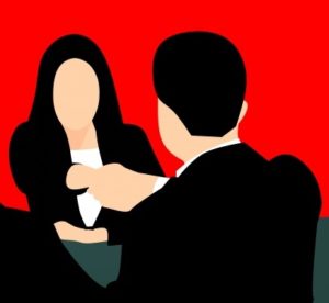 illustration of a woman and a man shaking hands across a table in business attire