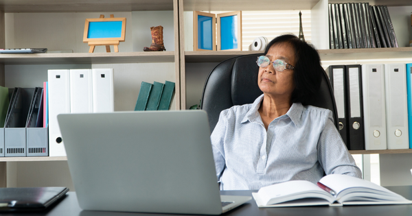 Older woman using a computer in an office environment 