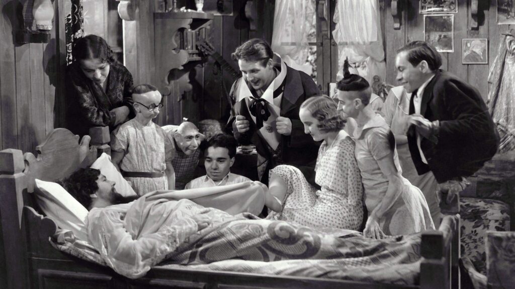 Screenshot from Freaks - a group of multiple disabled people at someone's bedside 