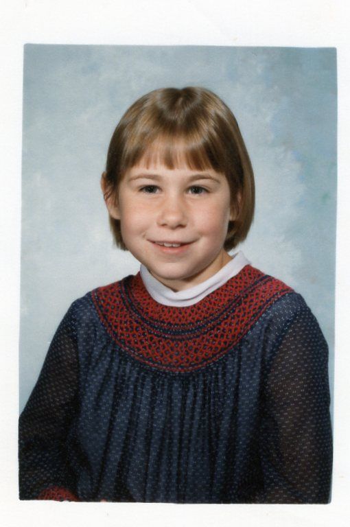 Dom as a young child, wearing a blue sweater