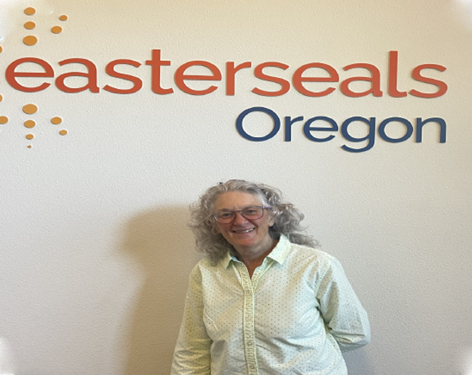 Older woman standing in front of the Easterseals Oregon Sign