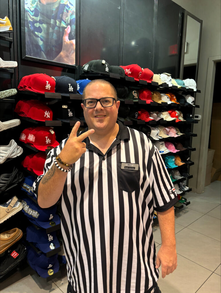 Employee at a shoe store smiling 